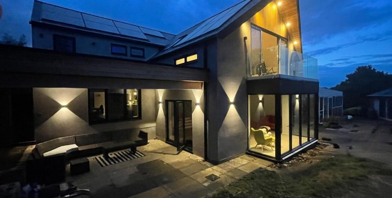 low light grey house with sofit spots wall lights finished in grey and black 